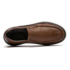 Macro view of men's brown textured leather loafers with slip-on design and soft sole.