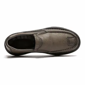 Macro top-down view showing the textured leather and stitching of men's casual grey loafer