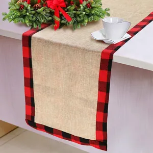 Detailed view of burlap Christmas table runner with red and black buffalo plaid edges.
