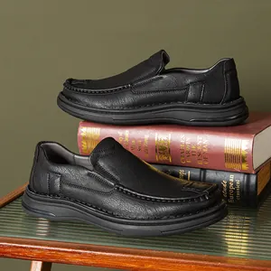 Detail view of black slip-on loafers for men with decorative stitching and soft soles