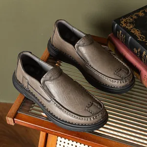 Detail view of men's brown leather slip-on loafers with textured surface and soft sole