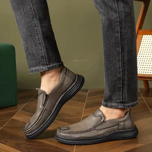 Close-up of grey slip-on leather loafers for men with thick black rubber soles