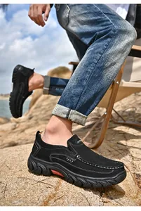 Detail view of men's black suede leather outdoor casual loafers with stitching.