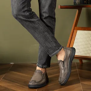 Close-up detail of stylish men's grey leather slip-on loafers with durable soft soles