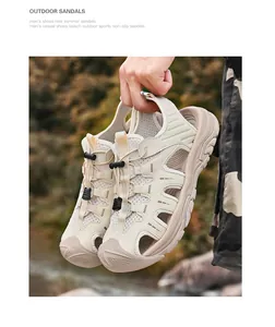 Close-up of men's beige closed-toe breathable outdoor sports sandals held by hand