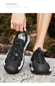 Detail view of men's breathable outdoor sandals with non-slip sole in natural setting.