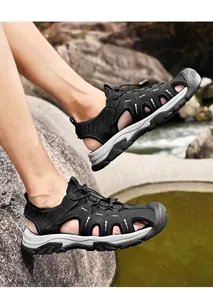 Close-up view of black breathable outdoor closed-toe sports sandals on model