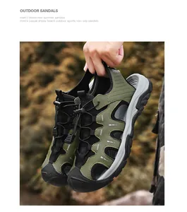 Close-up of olive green men's closed-toe outdoor sandals being held against nature background