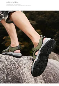 Detail of men's non-slip outdoor closed-toe sandals on a rocky terrain
