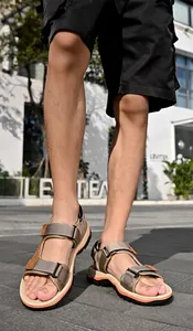 Detailed view of men's khaki outdoor sports sandals with velcro straps and non-slip sole.