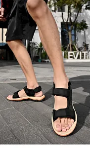 Macro view of men's black sport sandals featuring non-slip soft soles and velcro straps