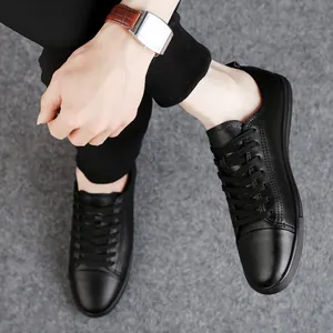 Men's black genuine leather casual sneakers with soft sole and stylish low-top design.