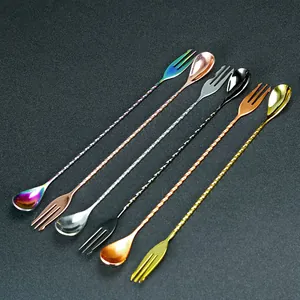 Detailed view of long bar spoon with twisted handle and fork end, colorful metal cocktail tool.