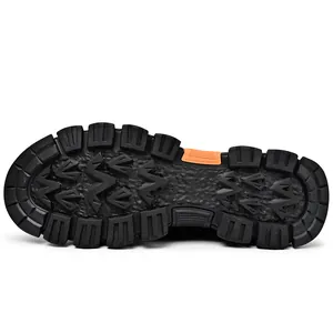 Detailed macro shot of the rugged black anti-slip rubber outsole for mens outdoor hiking boots