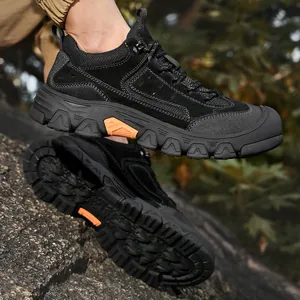 Detailed side view of durable black men's outdoor hiking shoes with rugged soles