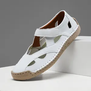 Side view detail of breathable white leather hollow out casual shoe with tan rubber sole