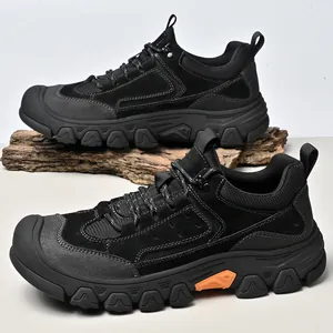 Durable black men's hiking shoes featuring suede mesh upper and rugged rubber outsole on wood