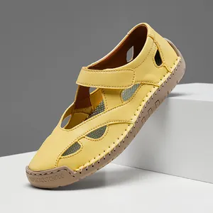 Detail shot of yellow hollow-out leather casual sandal for women on white display block