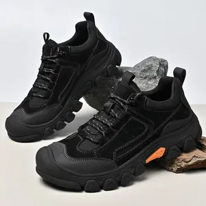 Detailed macro shot of rugged black outdoor hiking shoe with textured sole and suede finish