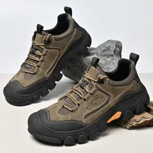 Detailed view of brown men's outdoor hiking shoes showing rugged suede and mesh materials