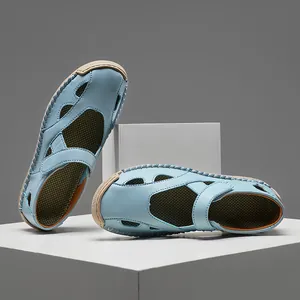 Detailed view of light blue leather hollow sandals with breathable design on white blocks