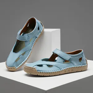 Comfortable light blue leather cutout sandals with velcro strap and white stitching details