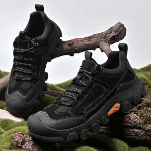 Side profile detail of durable black men's outdoor hiking shoes on mossy terrain