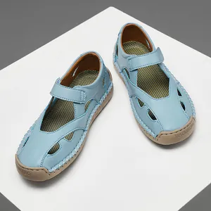 Close-up of light blue leather hollow sandals with breathable cut-out details