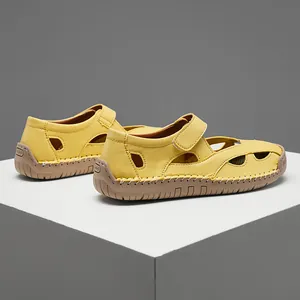 Side view macro detail of soft yellow leather hollow-out summer sandals for women