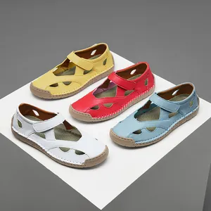 Close-up of comfortable hollow out leather sandals in yellow, red, blue, and white.
