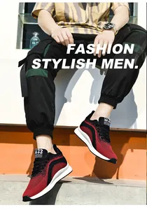 Macro view of red and black fly-knit height-increasing men's sports sneakers on foot