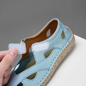 Close-up view of the adjustable Velcro closure on a stylish light blue leather sandal.