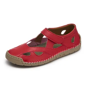 Side detail of women's red leather hollow sandals showing stitching and rubber sole