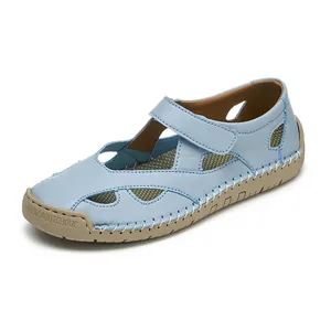 Close-up of light blue leather hollow-out sandals with breathable mesh and velcro strap