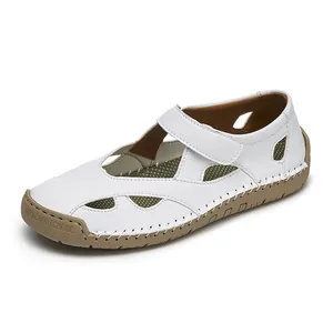 Detailed view of white leather hollow out sandals with hand-stitched rubber sole for women