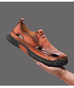 Macro detail van bruine ademende lederen sandalen voor heren, met de hand vastgehouden