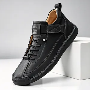 Close-up of black casual leather shoe with handmade stitching and rubber sole