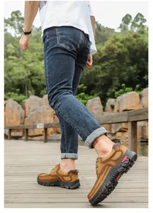 Close-up view of premium brown leather men's outdoor casual shoes on a wooden boardwalk