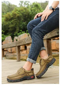 Detailed side view of men's genuine leather outdoor shoes on a rustic wooden deck