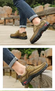 Side view detail of men's brown genuine leather outdoor hiking shoes on a wooden bridge