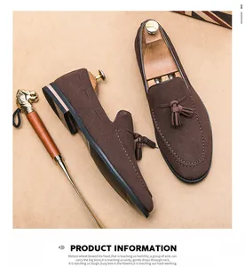 Macro detail of brown suede loafers featuring elegant tassels and refined stitching.