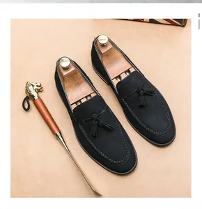 Detailed view of men's vintage black suede tassel loafers with classic stitching