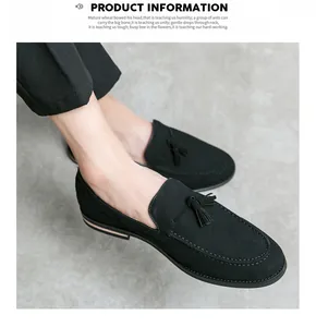 Elegant black suede loafers for men featuring classic tassel detail on a grey floor