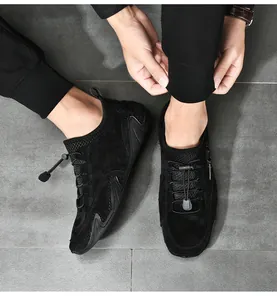Top view of men's black suede loafers with unique octopus traction sole and cord laces.