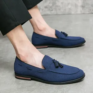 Classic men's navy blue suede loafers featuring vintage tassel and pointed toe design