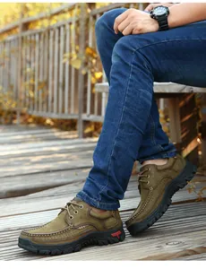 Detail view of men's genuine leather outdoor shoes worn on a wooden deck