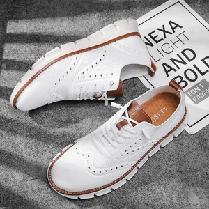 Detailed view of breathable white mesh casual shoes with stylish brogue patterns.