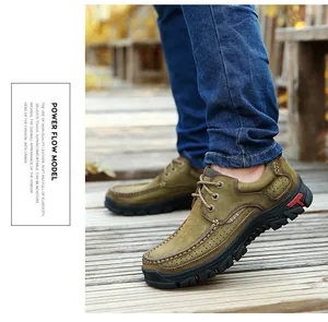 Detailed side view of men's premium genuine leather outdoor walking shoes on a wooden path