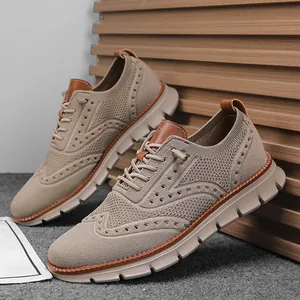 Close-up detail view of men's khaki fly-knit casual shoes with decorative brogue patterns