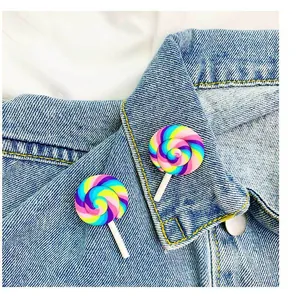 Cute rainbow swirl lollipop brooches made of soft clay decorative pins on a denim jacket